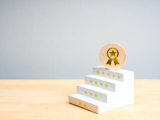 Wooden award on star-decorated staircase symbolizes ratings, customer satisfaction, achievement, business success, performance improvement, recognition, service quality, and step-by-step development.