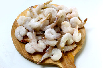 Frozen shrimps on wooden board.