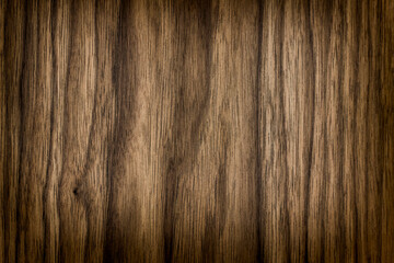 background is made of old wood. an old dark brown board. the texture of a rustic table. american valnut, a place for a text or object, frame, vignetting, view. the effect of aging, horizontal