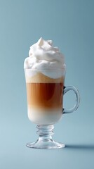 Hot whipped coffee topped with thick milk foam served in a glass cup
