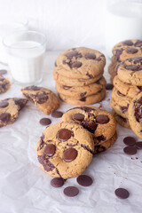 freshly baked homemade chocolate chip cookies on baking paper background