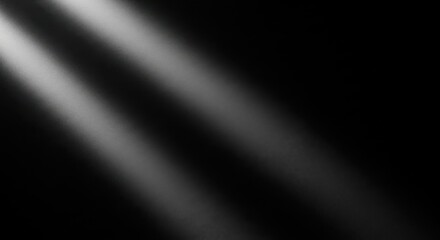 Dramatic light beams cutting through darkness creating a moody atmosphere and visual effect