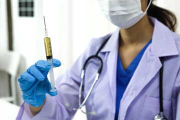 Hand holding syringe and vaccine treatment from Coronavirus covid-19 infection.