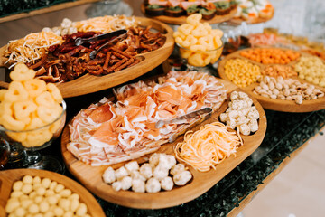 Elegant spread of gourmet snacks and treats at a festive gathering in a stylish venue