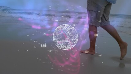 Animation of rotating globe and numbers over low section of caucasian man walking at sandy beach - Powered by Adobe