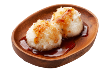 Coconut rice balls or dumplings topped with syrup and shredded coconut on wooden plate, isolated on white transparent background, concept of Polynesian Snacks Faikakai dessert cuisine