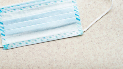 Medical single use face mask laying on table flat lay view