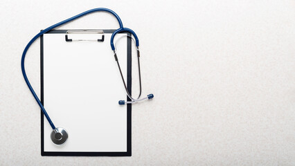 Healthcare medical background of stethoscope and clipboard flat lay on table with copy-space
