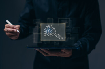 research, business, people and education concept - Business man using laptop with marker drawing magnifier