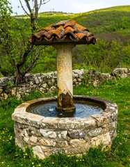 Ornate stone fountain with tiled roof