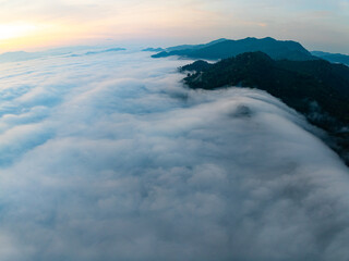 Amazing Sunrise over mountains hills covered with mist, Aerial view landscape drone shot beautiful sky colorful light nature background