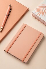 Pastel peach stationery set with notebooks and pen on desk