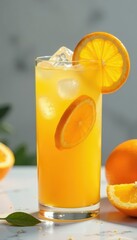 Fototapeta premium Iced orange juice with orange slices in tall glass on marble , delicious, summer, citrus fruit