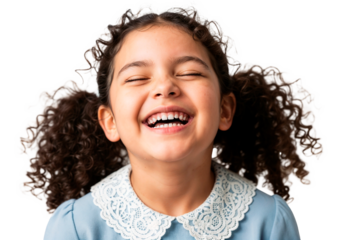 Child with curly hair joyfully laughing indoors, showcasing happiness and innocence during a moment of playfulness