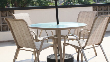 Chairs and tables in a coffee cafe are neatly arranged on the rooftop.