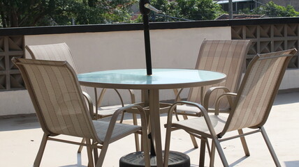 Chairs and tables in a coffee cafe are neatly arranged on the rooftop.