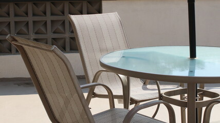 Chairs and tables in a coffee cafe are neatly arranged on the rooftop.