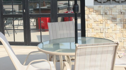 Chairs and tables in a coffee cafe are neatly arranged on the rooftop.