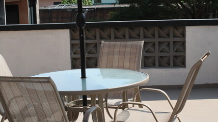 Chairs and tables in a coffee cafe are neatly arranged on the rooftop.