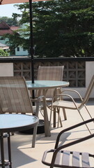 Chairs and tables in a coffee cafe are neatly arranged on the rooftop.
