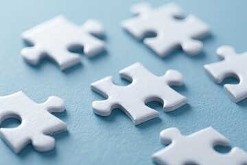 Fototapeta premium White puzzle pieces on light blue background