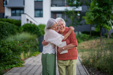 Portrait of beautiful adult daughter with old mother.