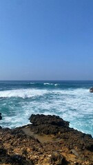 view of the sea waves from the top of the rocks