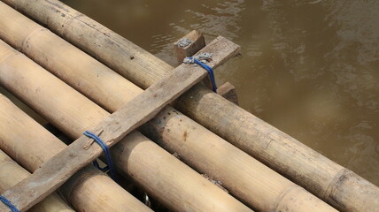 a bridge for crossing made of bamboo trees, woven and nailed in a row