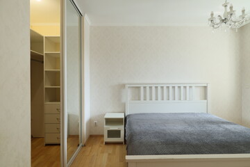 A Modern Minimalist Bedroom with an elegant Mirror Wardrobe for style and functionality