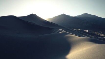 Serene mountainous terrain with smooth dunes covered in light sand, sunset or sunrise casting shadows,