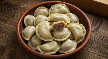 Pierogi in bowl on wooden table