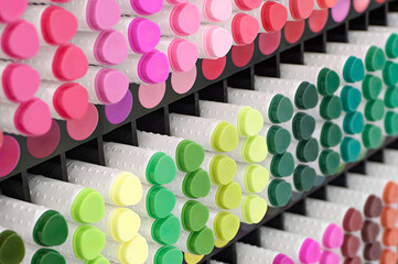 A variety of markers in various colors on a display of products for artists