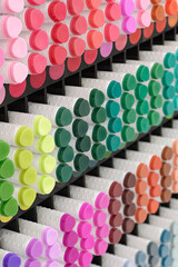A variety of markers in various colors on a display of products for artists