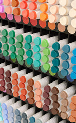 A variety of markers in various colors on a display of products for artists