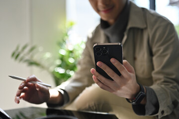 Close-Up of Hands Using Smartphone and Stylus at Work Desk, Mobile Productivity and Digital Tools