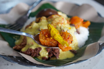 Gudeg Telor, captured on September 1, 2025. Traditional Javanese dish of young jackfruit stew served with hard-boiled egg, rich brown coconut milk sauce, authentic Indonesian culinary heritage