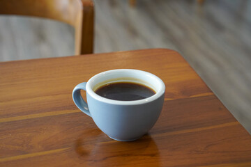 Hot Americano Coffee, captured on September 1, 2025. Steaming black coffee served in white ceramic cup on wooden table, cozy minimalist style, perfect for café, breakfast, and lifestyle themes