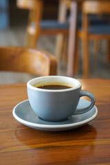 Hot Americano Coffee, captured on September 1, 2025. Steaming black coffee served in white ceramic cup on wooden table, cozy minimalist style, perfect for café, breakfast, and lifestyle themes