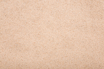 Fototapeta na wymiar Dry light brown sea sand background. Closeup. Empty place for text. Top down view.