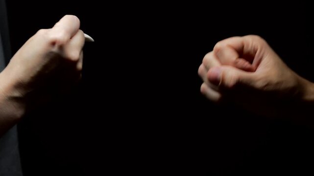 Rock paper scissors game.
decision making with the help of the game.
Man and woman playing a children's game on a black background.
Decision making and discussion