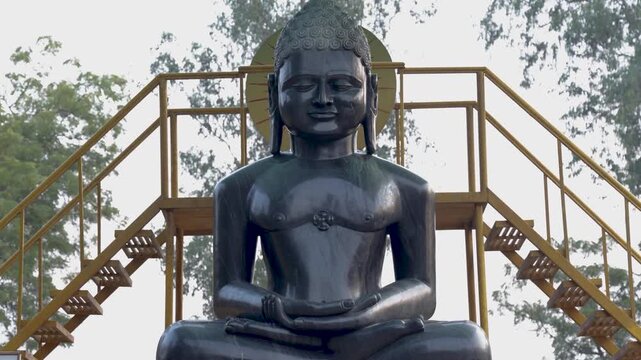 serene black marble buddha idol at outdoor in daylight at sarnath in day at Sarnath near Varanasi, India.