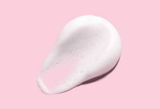 texture foam mousse foam cosmetic smear sample on pink background