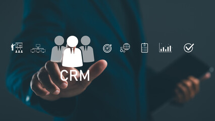 A hand reaches towards CRM icons, symbolizing customer relationship management and digital business...