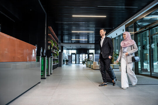 Elegant couple entering the business center and looking confident