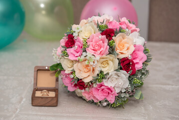 Soap Flower bouquet, arranged in a colorful composition, next to a wooden box with rings. Bride's bouquet, 2026