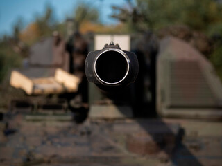 Close-up frontal view of artillery barrel muzzle with crew in background