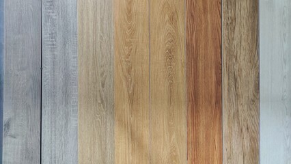 Various wood texture samples displayed in a supermarket, offered as options for flooring or wall panels, featuring natural grain patterns for home and interior building materials