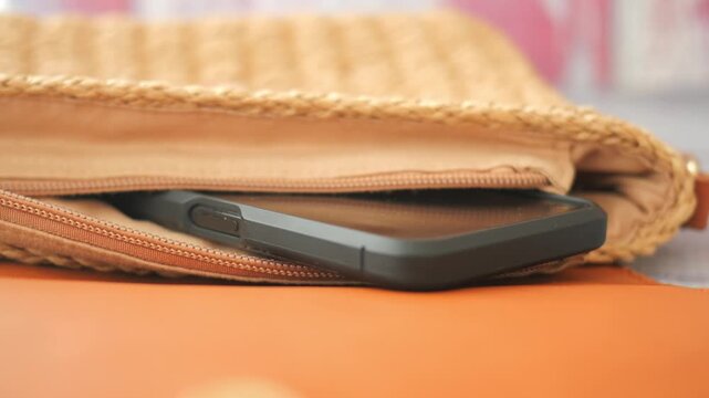 Stylish bag with smartphone resting on table