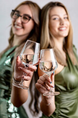 Close-up hands holding champagne flutes, festive toast
