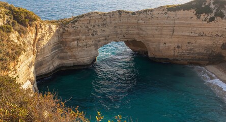 Obraz premium Raouche Rocks at Sunset, Beirut A Majestic Arch Over the Sea, Lebanon.